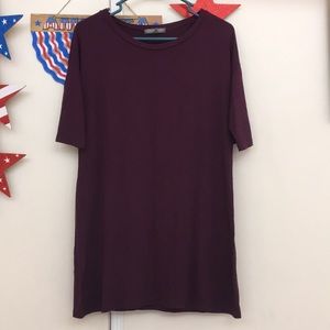 Purple tunic shirt with elbow length sleeves.